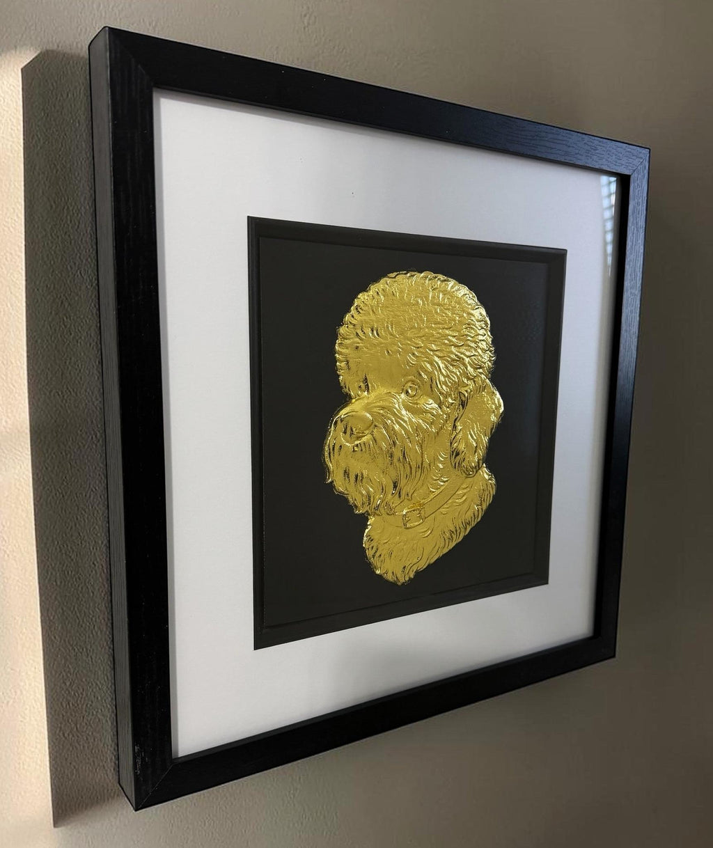 Angled wall view of a gold Dandie Dinmont Terrier portrait in a black box frame with glass front and black inner surround.