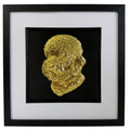 Front view of a gold Dandie Dinmont Terrier relief portrait in a square black frame with a wide white mount and black inner surround.