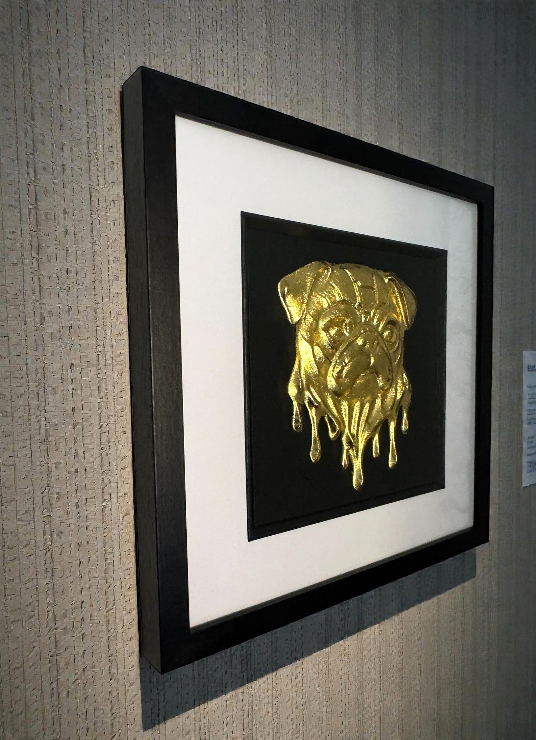 Pug wall art gold mounted to a modern gallery style wall