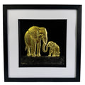 Framed elephant mother and baby wall art in goldleaf relief on a black background with white mount and black frame