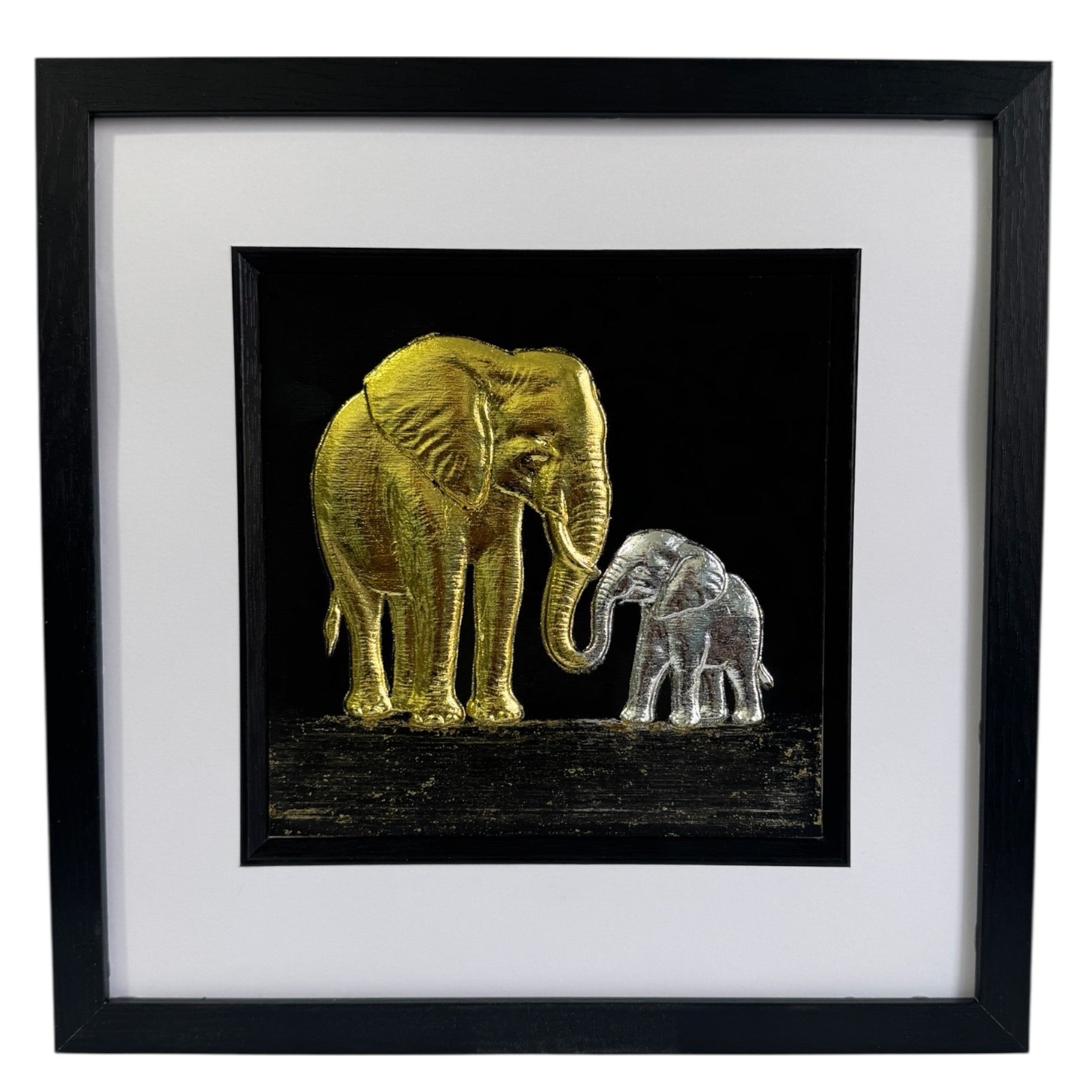 Framed elephant mother and baby wall art with gold leaf mother and silver leaf calf on a black background with white mount and black frame