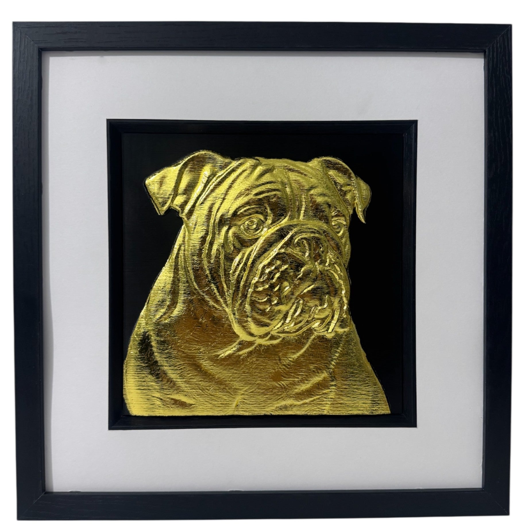 Framed English bulldog wall art in gold leaf relief, centred on a black background with white mount and black wooden frame