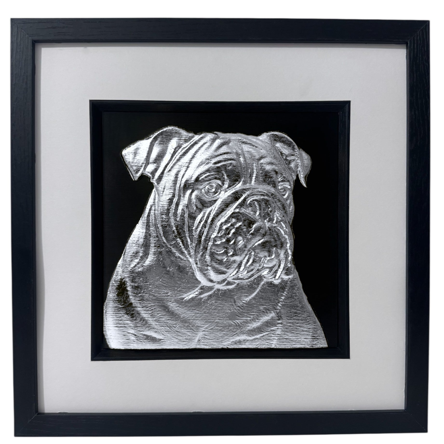 English Bulldog framed wall art showing a sculpted dog portrait in silver leaf, set on a black background with white mount and black wooden frame
