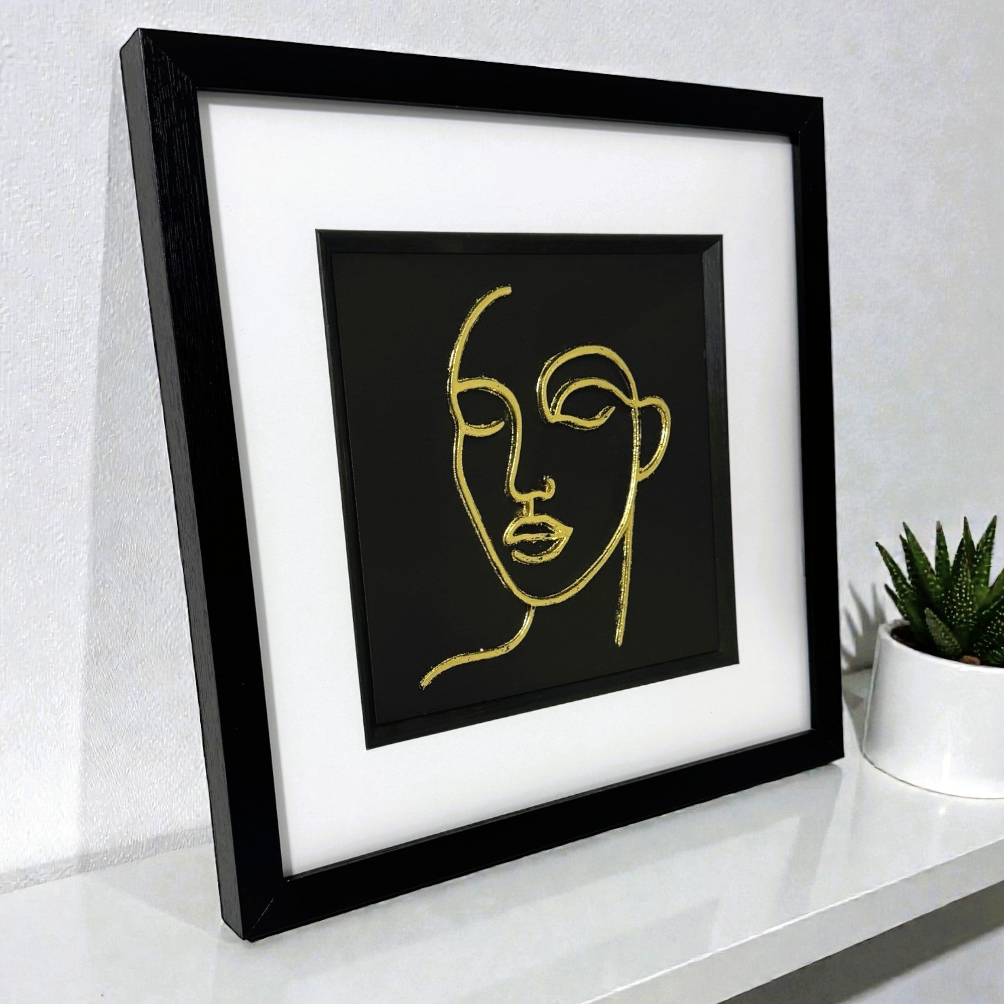 Gold leaf abstract female face line art framed with white mount