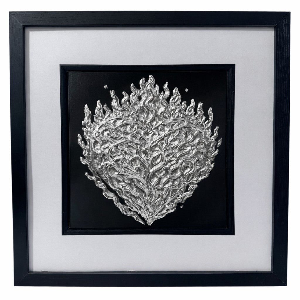 Front-facing silver leaf flaming heart wall art centred on a black background