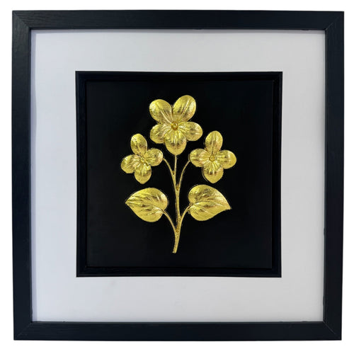 Gold framed floral relief with three flowers and two leaves on a black background with a wide white mount and black inner surround