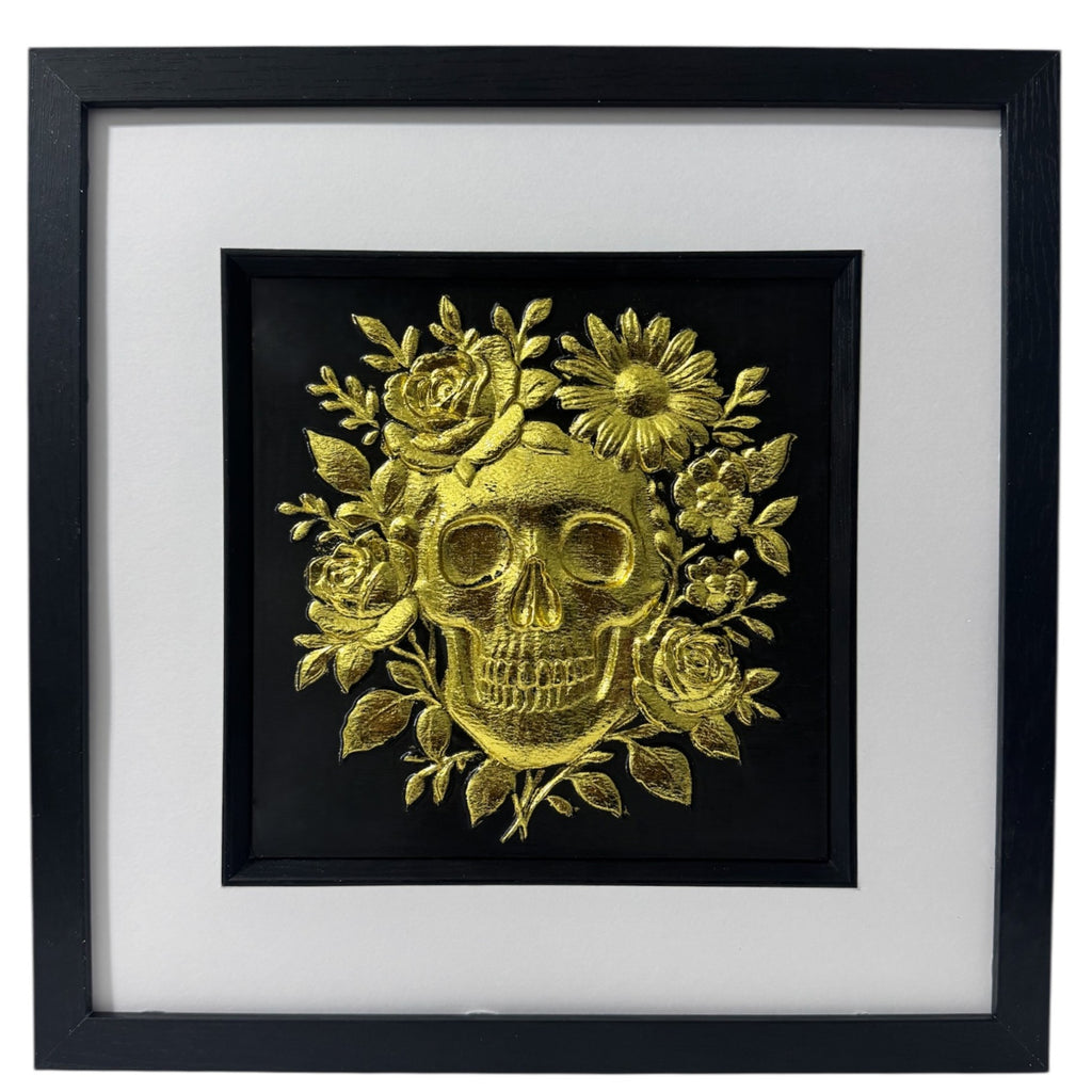 Gold leaf floral skull wall art with roses and daisies on black background