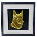 German Shepherd framed wall art showing a sculpted dog portrait in gold leaf, set on a black background with white mount and black wooden frame
