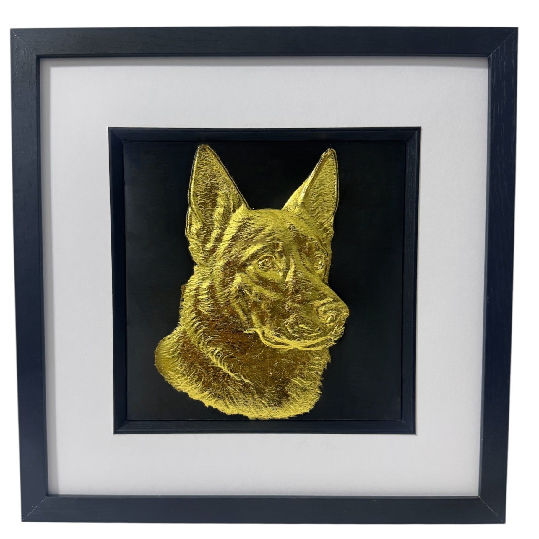 German Shepherd framed wall art showing a sculpted dog portrait in gold leaf, set on a black background with white mount and black wooden frame
