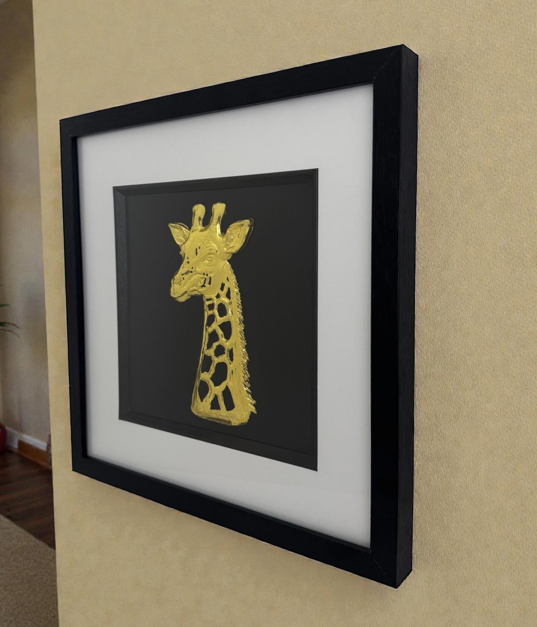 Giraffe wall art framed in gold leaf, 3D relief safari animal wall decor on a neutral wall.