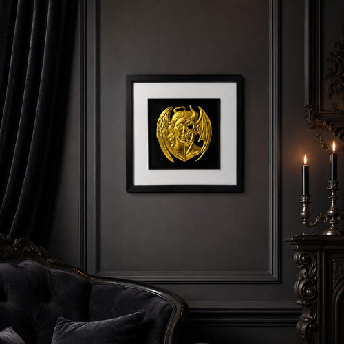 Framed gold angel and demon gothic 3D wall art on a dark luxury interior wall with black frame, white mount and candlelit styling.