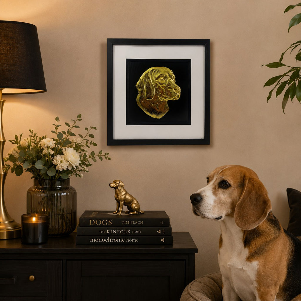 Gold Beagle dog wall art in a black square frame styled above a dark console with a beagle, dog books, warm lighting and neutral home decor.