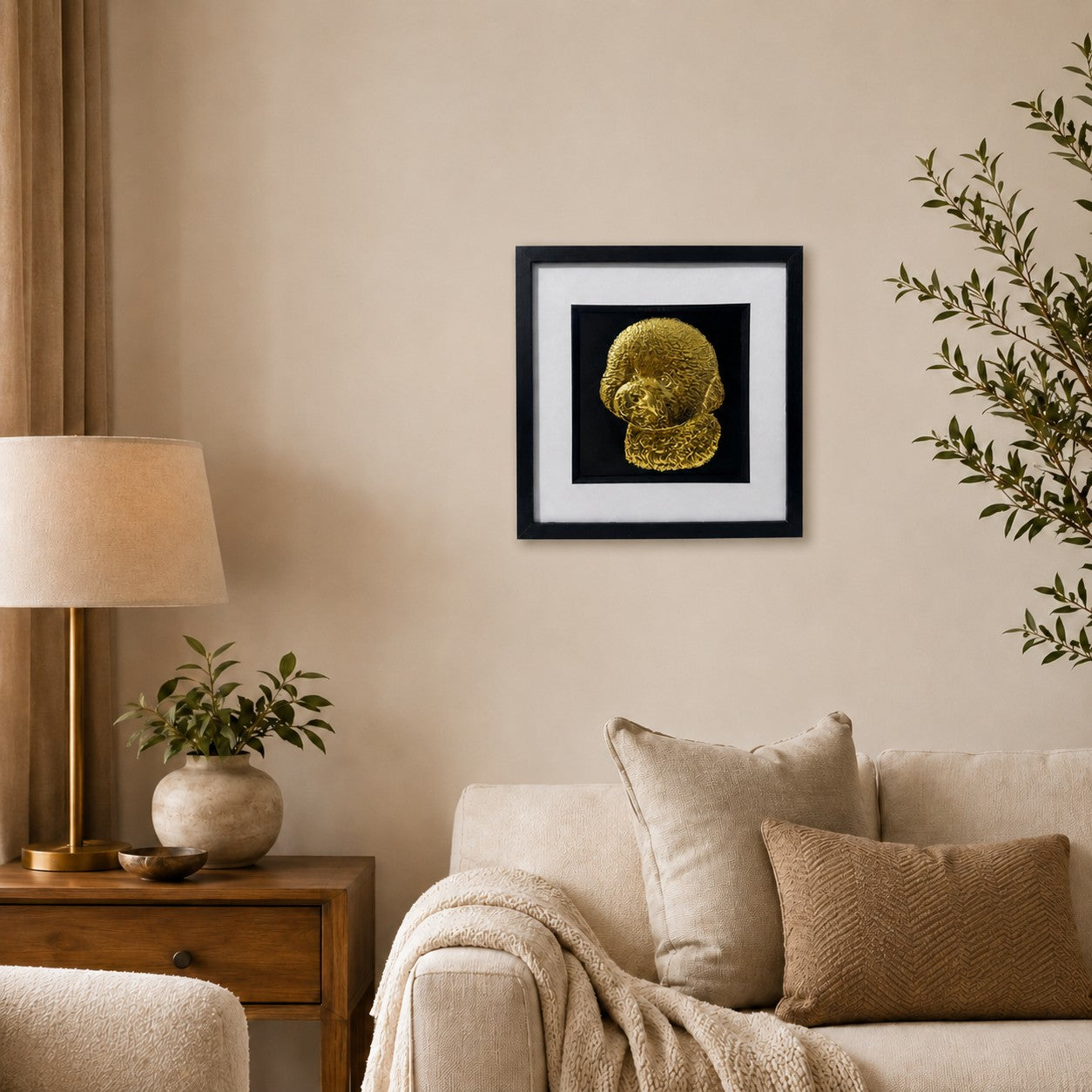 Gold Bichon Frise 3D wall art in a black frame displayed on a warm neutral living room wall with soft textiles, wood and greenery.