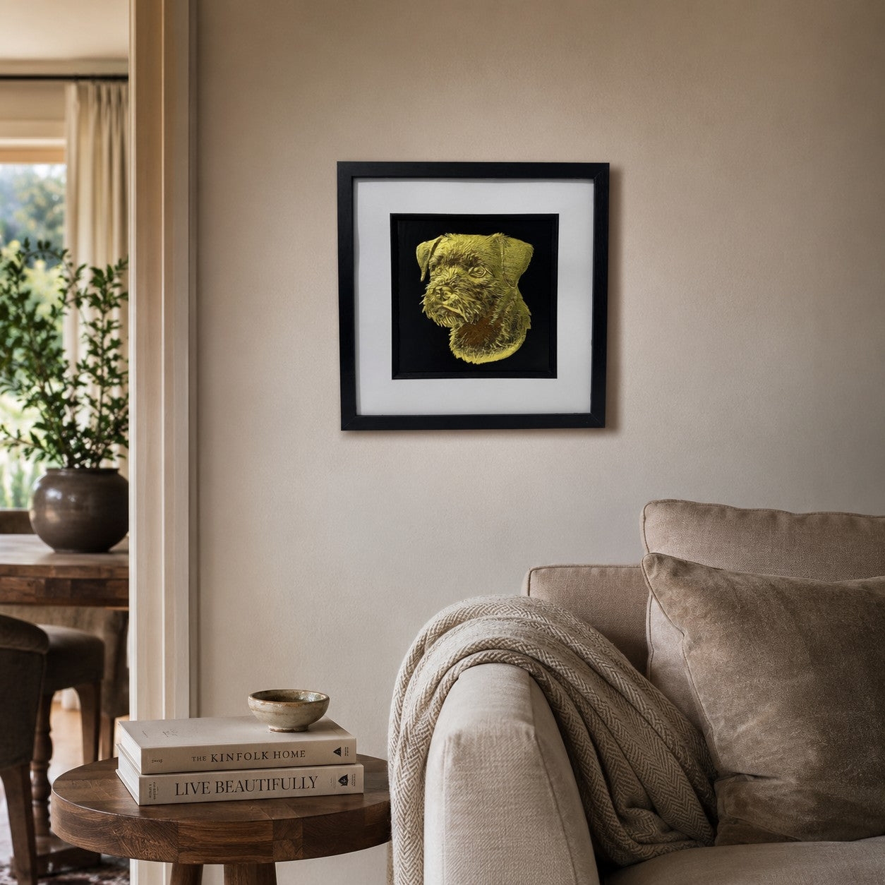 Gold Border Terrier 3D wall art in a black frame displayed on a warm neutral living room wall with soft furnishings, natural wood and cosy decor.
