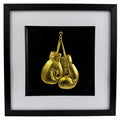 Framed gold boxing gloves wall art with black frame, white mount and black background, featuring detailed gold leaf style boxing glove design for sports decor or boxing gift.
