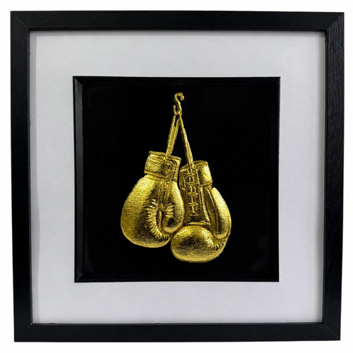 Framed gold boxing gloves wall art with black frame, white mount and black background, featuring detailed gold leaf style boxing glove design for sports decor or boxing gift.