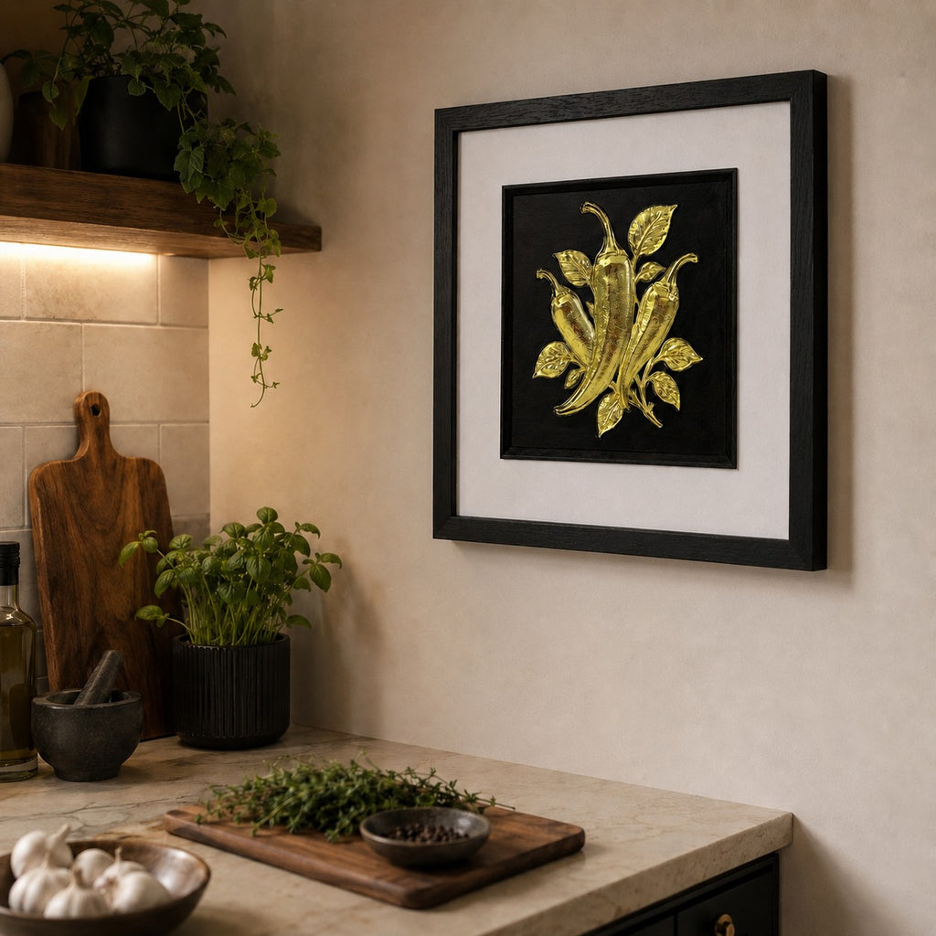 Gold chilli pepper 3D framed kitchen artwork styled with plants, chopping boards and neutral tones.