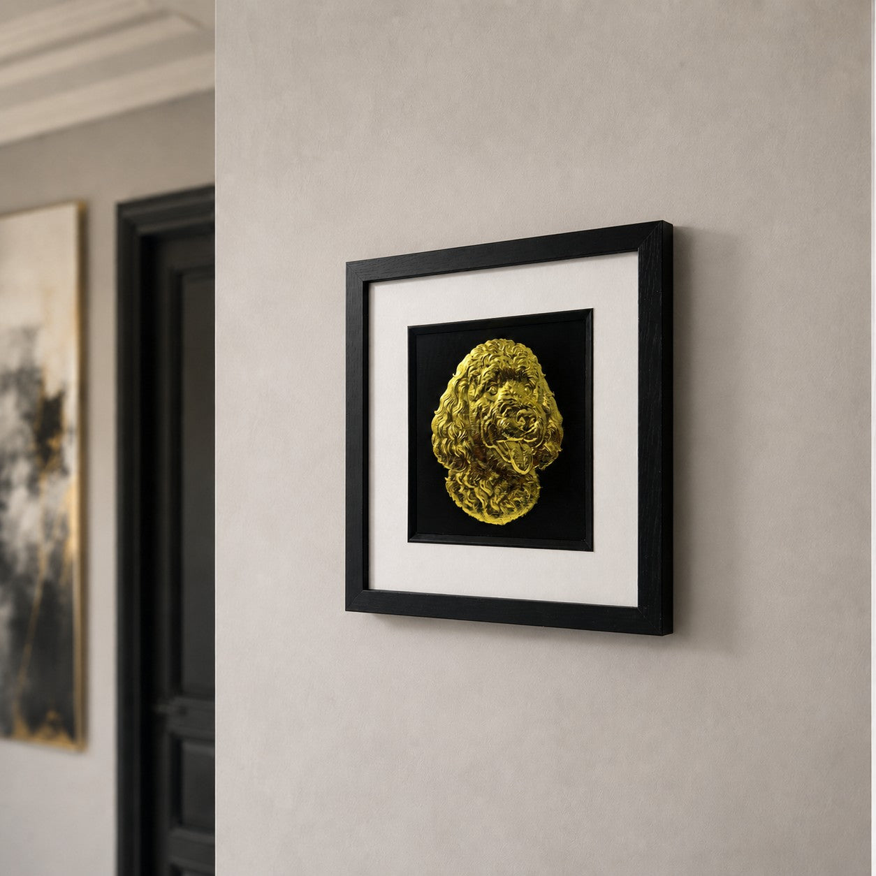 Angled wall view of Gold Doodle dog 3D wall art with gold leaf detail, black frame and white mount, displayed in a modern neutral hallway setting.