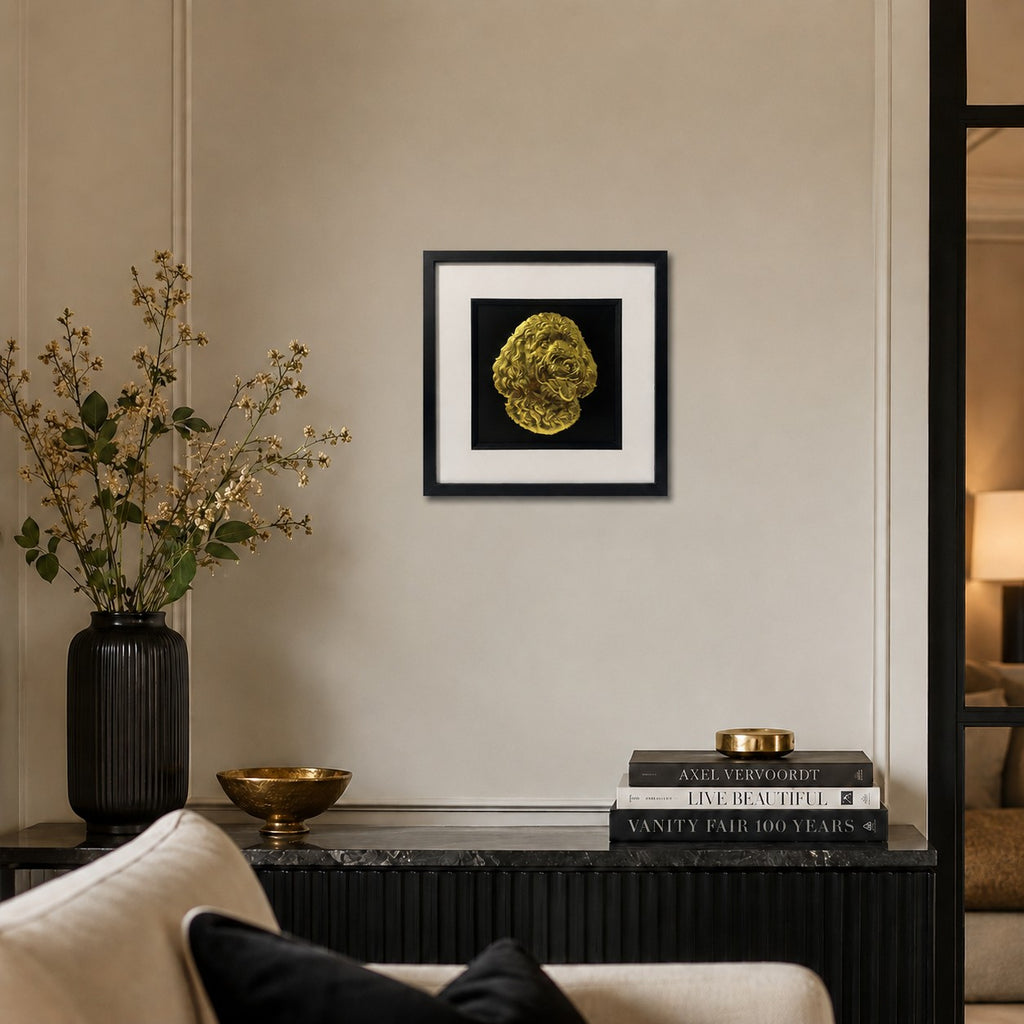 Gold Doodle dog 3D wall art in a black square frame with white mount, shown on a neutral living room wall with black and gold home décor accents.