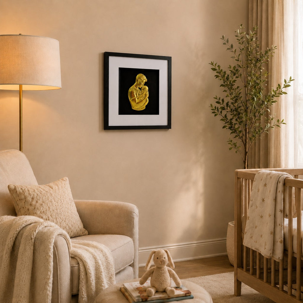 Gold father and baby framed artwork in a calm nursery with cot, armchair, lamp and soft textiles.