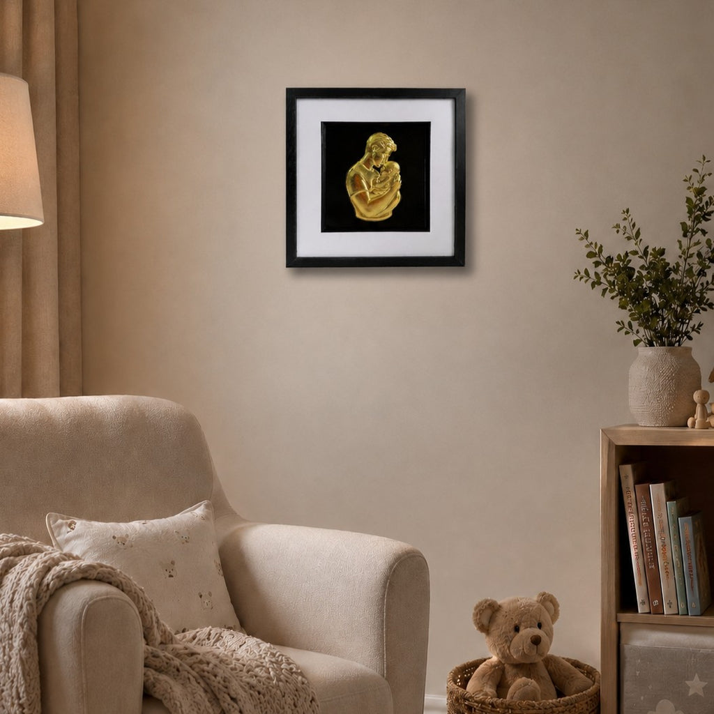 Gold father and baby 3D framed artwork styled in a neutral nursery with armchair, lamp and teddy bear.