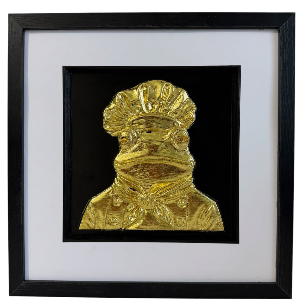 Gold frog chef raised relief in black square frame with white mount and black inner surround