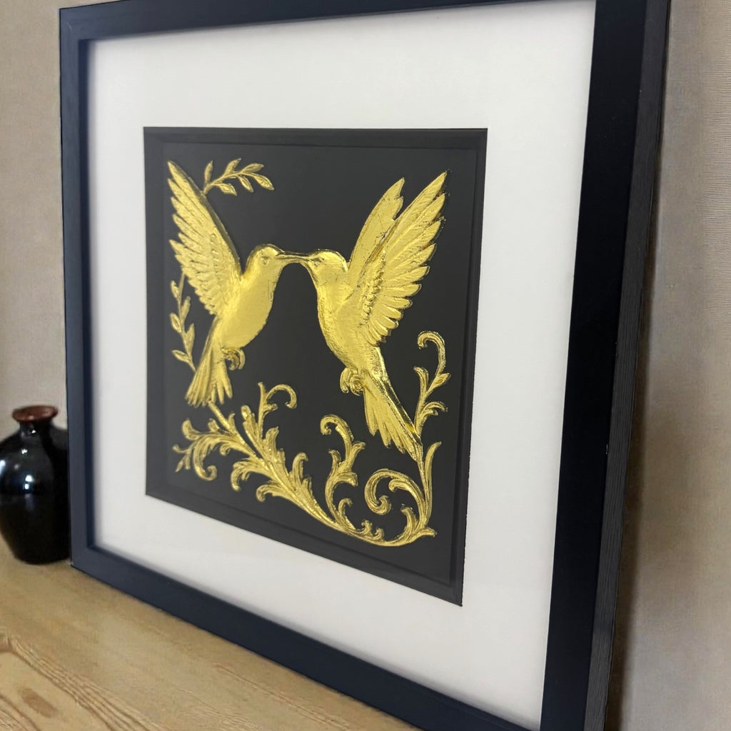 Gold hummingbird framed art styled on a wooden shelf. Unique hand-gilded anniversary or wedding gift idea with luxury finish.
