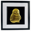 Framed gold leaf baby penguin wall art with a black background and white mount, ideal for nursery decor or cute animal wall art.