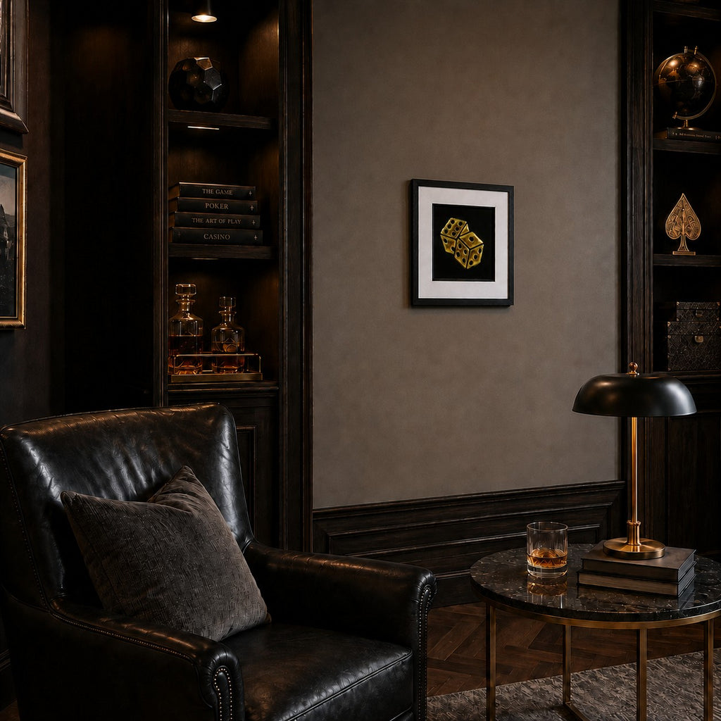 Angled view of framed gold leaf dice wall art styled in a dark luxury lounge with leather seating and warm brass accents.