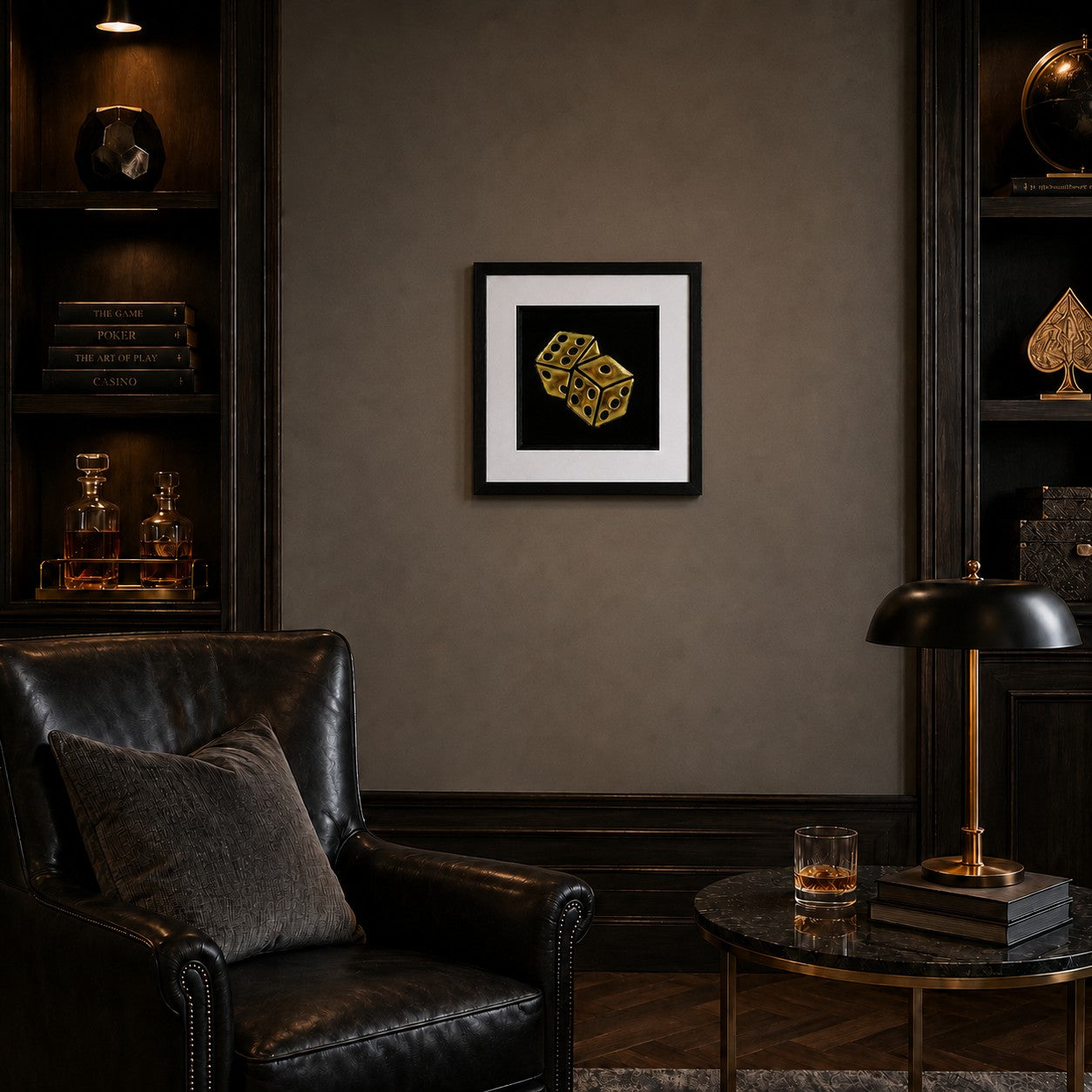 Framed gold leaf dice wall art displayed on a luxury games room wall with dark wood shelving, leather chair and warm lighting.