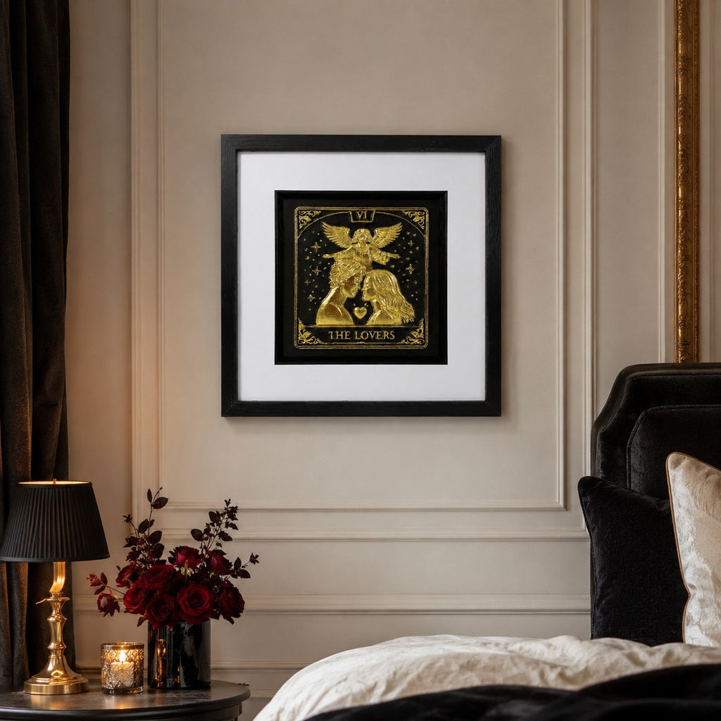 Gold The Lovers tarot card framed artwork hanging in a romantic bedroom with red roses, candlelight and black velvet styling