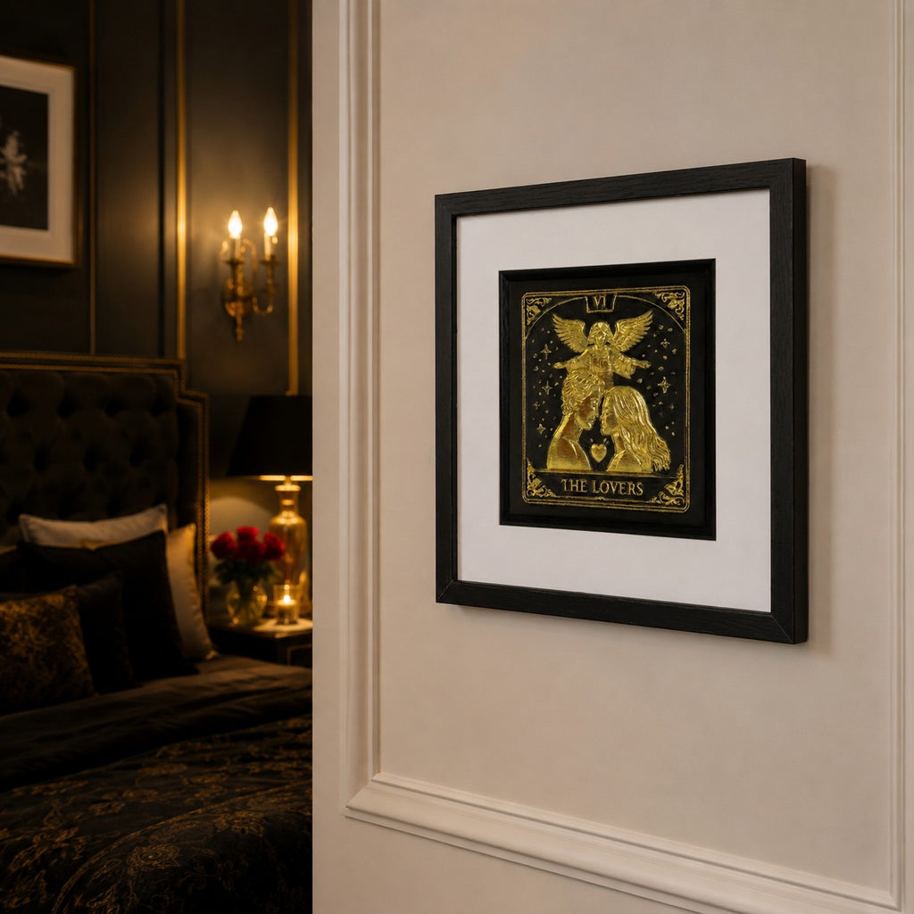 Angled view of Gold The Lovers tarot framed artwork on a cream panelled bedroom wall with warm lighting