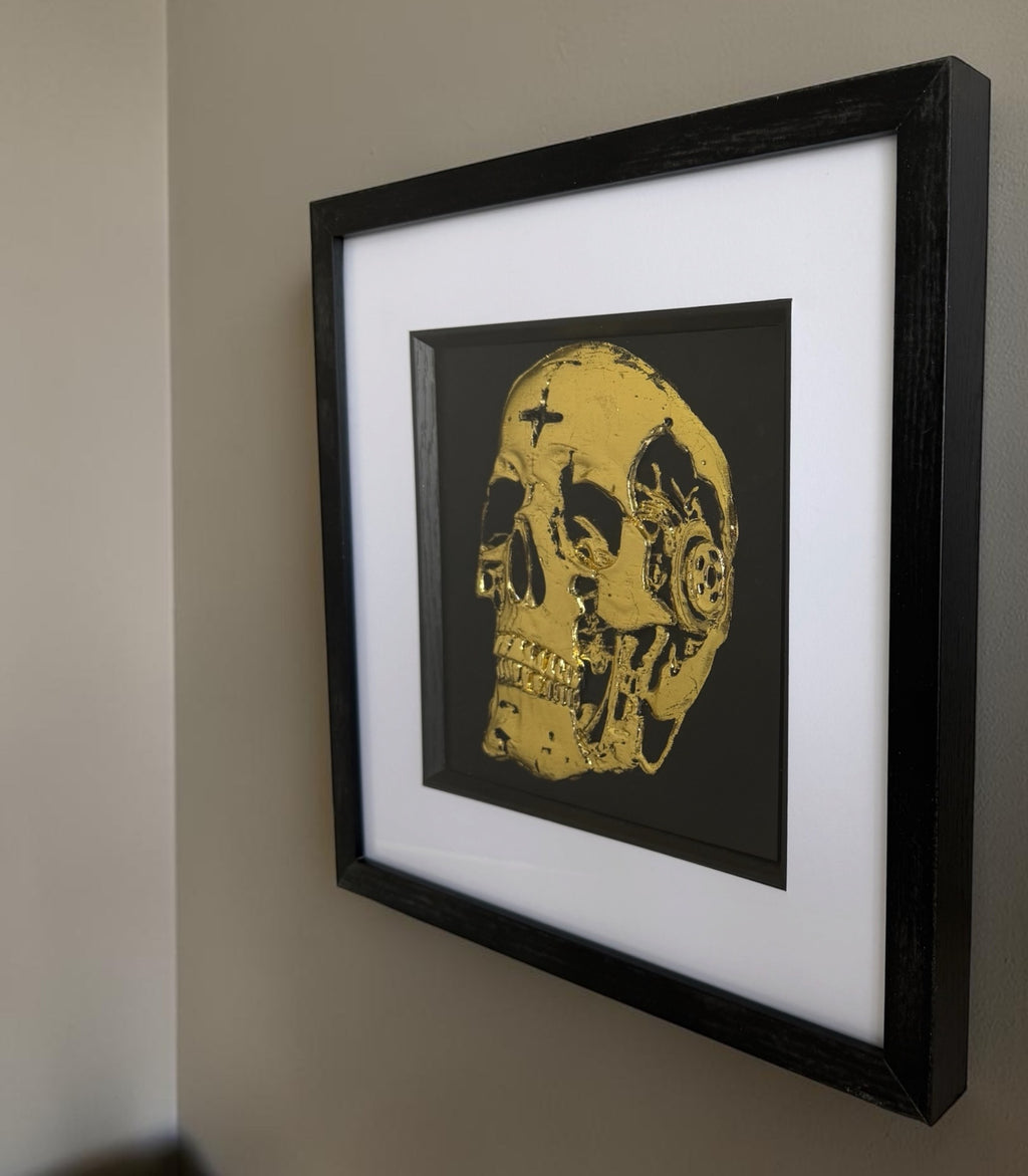 Angled view of mechanical skull wall art showing depth and frame detail