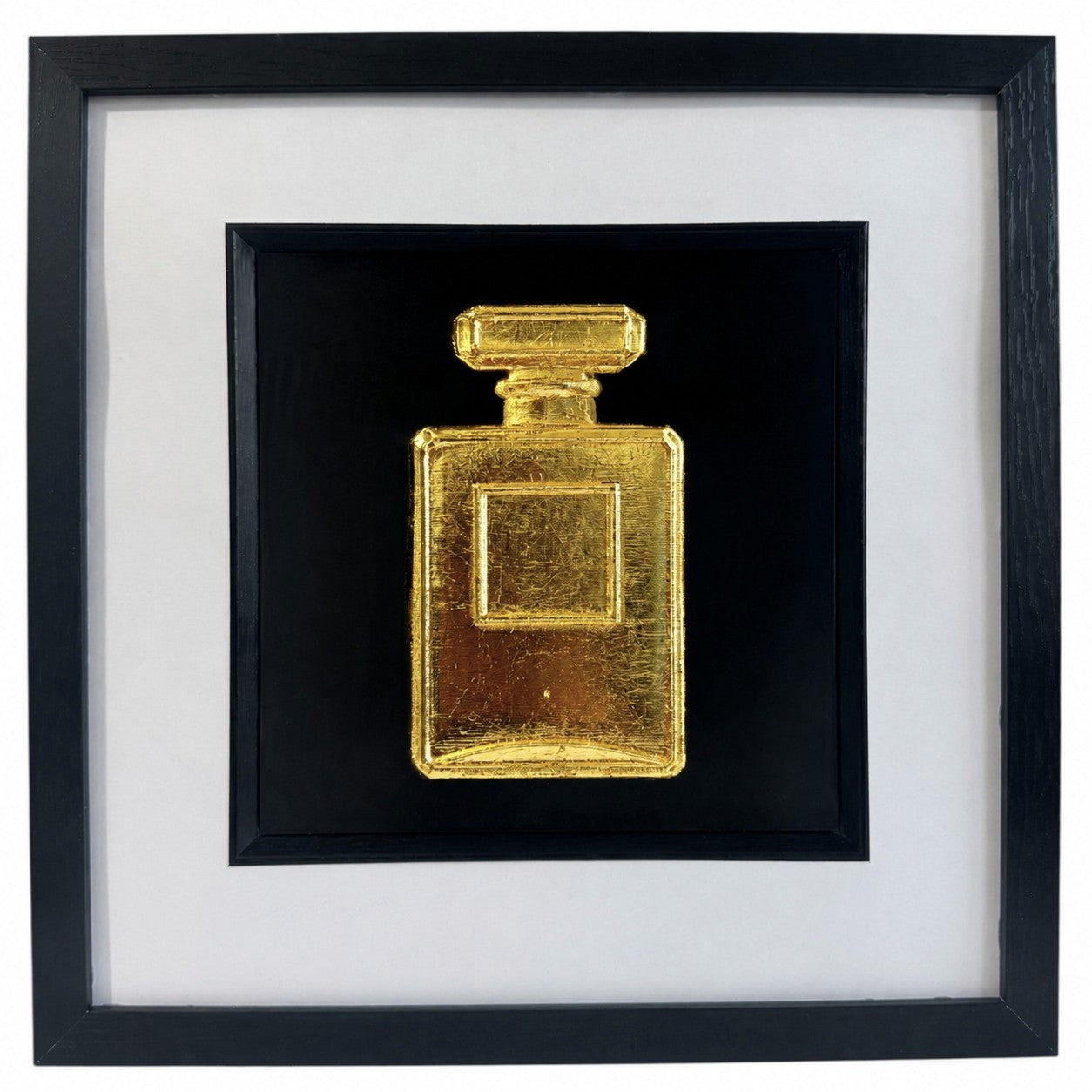 Gold leaf perfume bottle wall art in a black frame with white mount, featuring a hand gilded 3D relief design on a black background for elegant fashion inspired home decor.
