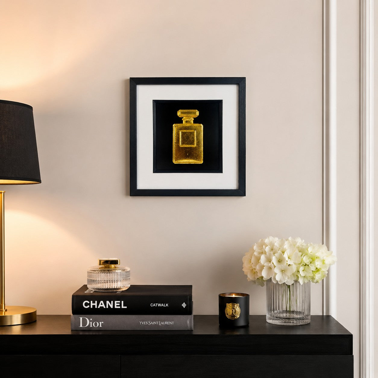Gold perfume bottle wall art displayed in a luxury dressing room setting, featuring a framed hand gilded gold leaf 3D relief design on a black background with elegant fashion inspired decor.