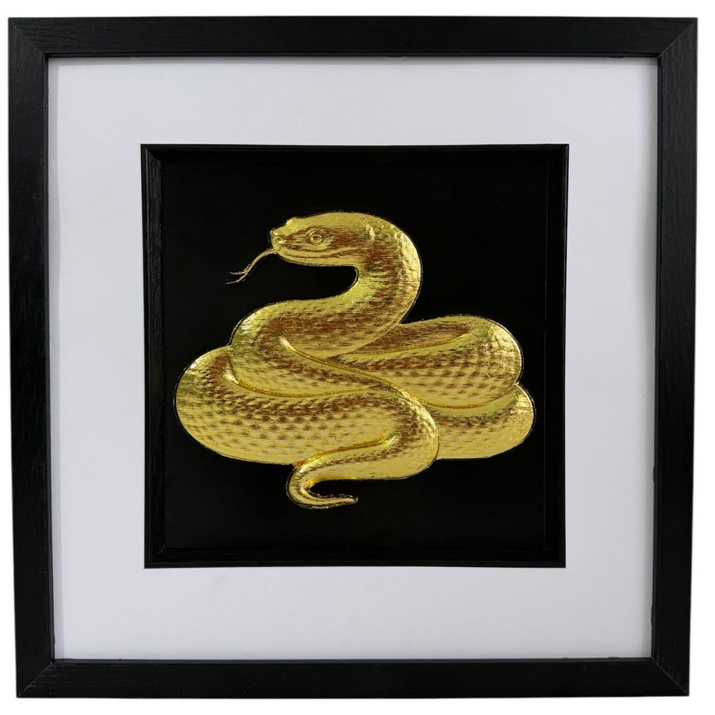 Gold framed snake relief artwork with coiled serpent, black centre, wide white mount and black square frame.