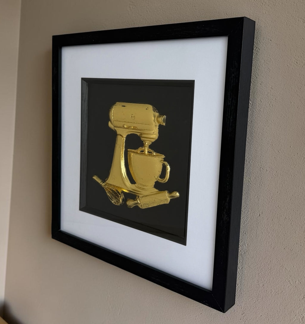 Side view of gold stand mixer kitchen artwork showing black box frame depth and white mount.