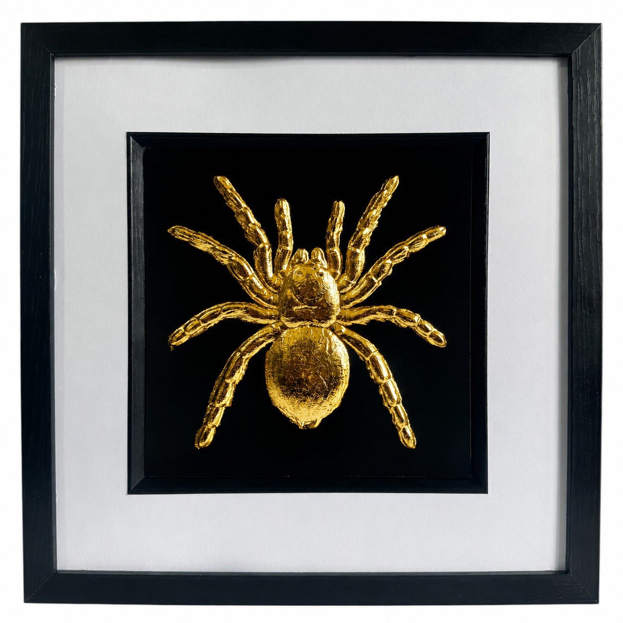 Framed tarantula spider wall art finished in realistic gold leaf, shown on a black background with a white mount and black frame for bold gothic wildlife decor.