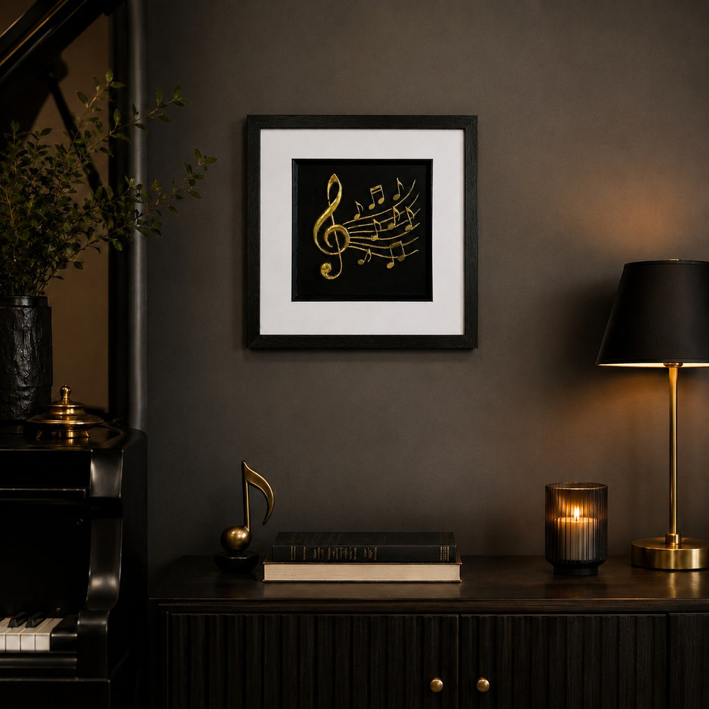 Gold treble clef framed artwork styled above a dark sideboard with piano, lamp, candlelight and books