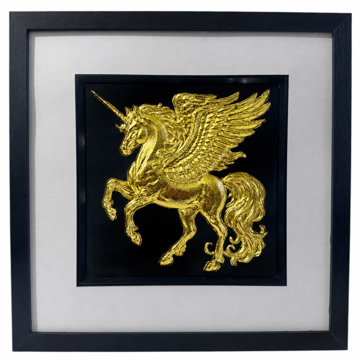 Framed winged unicorn wall art finished in realistic gold leaf, shown on a black background with a white mount and black frame for fantasy home decor.
