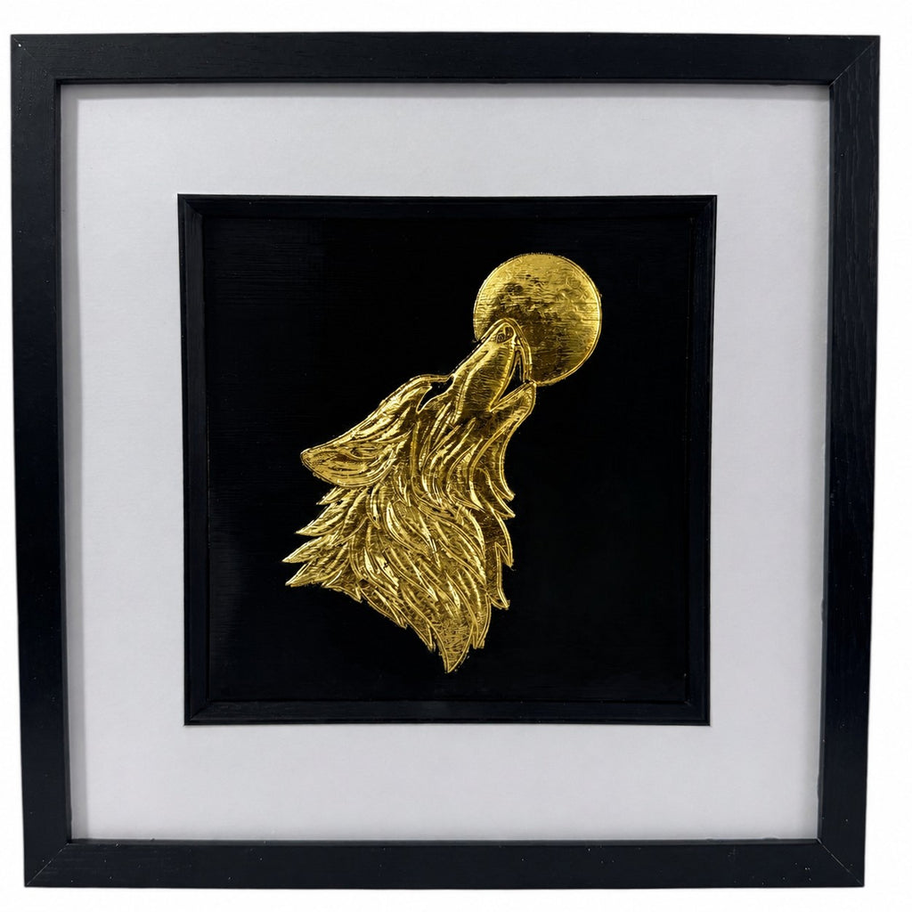 Gold wolf howling at the moon framed wall art with hand gilded gold leaf effect on a black background, displayed in a 33cm square black frame with white mount.