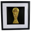 Gold World Cup trophy inspired 3D football wall art in a black box frame with white mount and black inner surround.