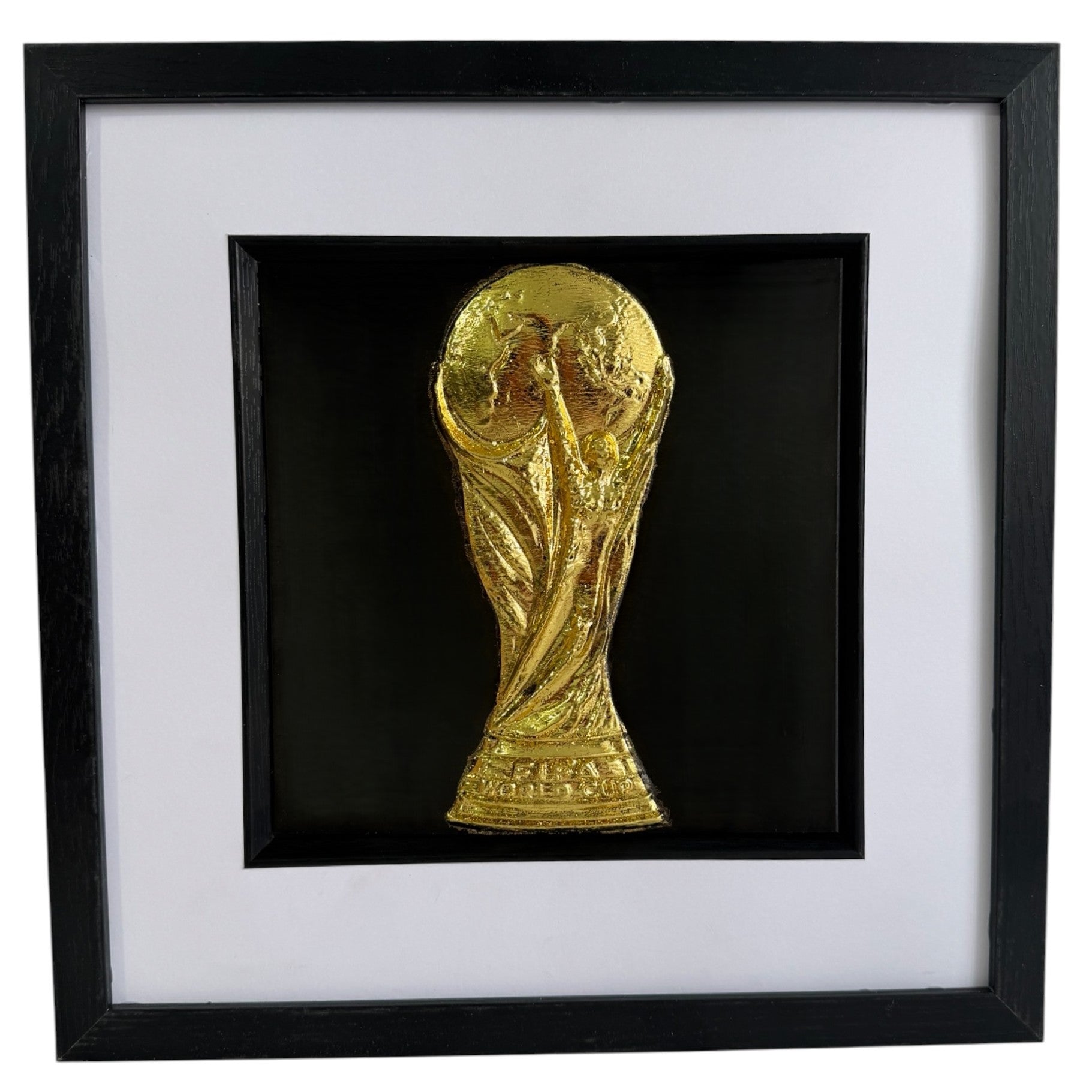 Gold World Cup trophy inspired 3D football wall art in a black box frame with white mount and black inner surround.