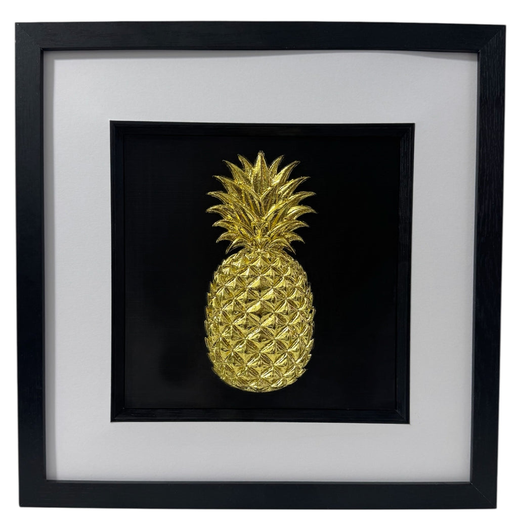 Gold leaf pineapple 3D kitchen wall art ain a deep black box frame with white mount and inner black surround, square framed wall art on black background