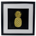 Gold leaf pineapple 3D kitchen wall art ain a deep black box frame with white mount and inner black surround, square framed wall art on black background