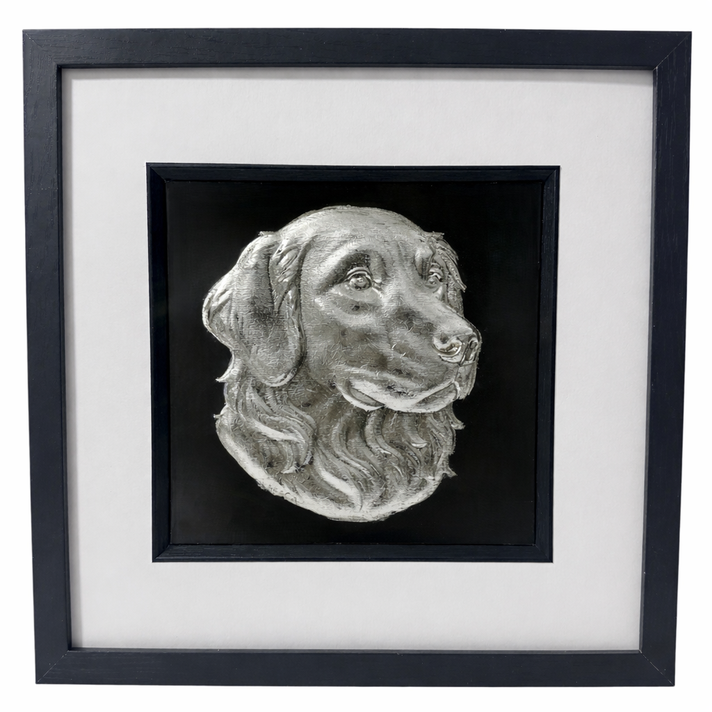 Golden Retriever framed wall art showing a sculpted dog portrait in silver leaf, set on a black background with white mount and black wooden frame
