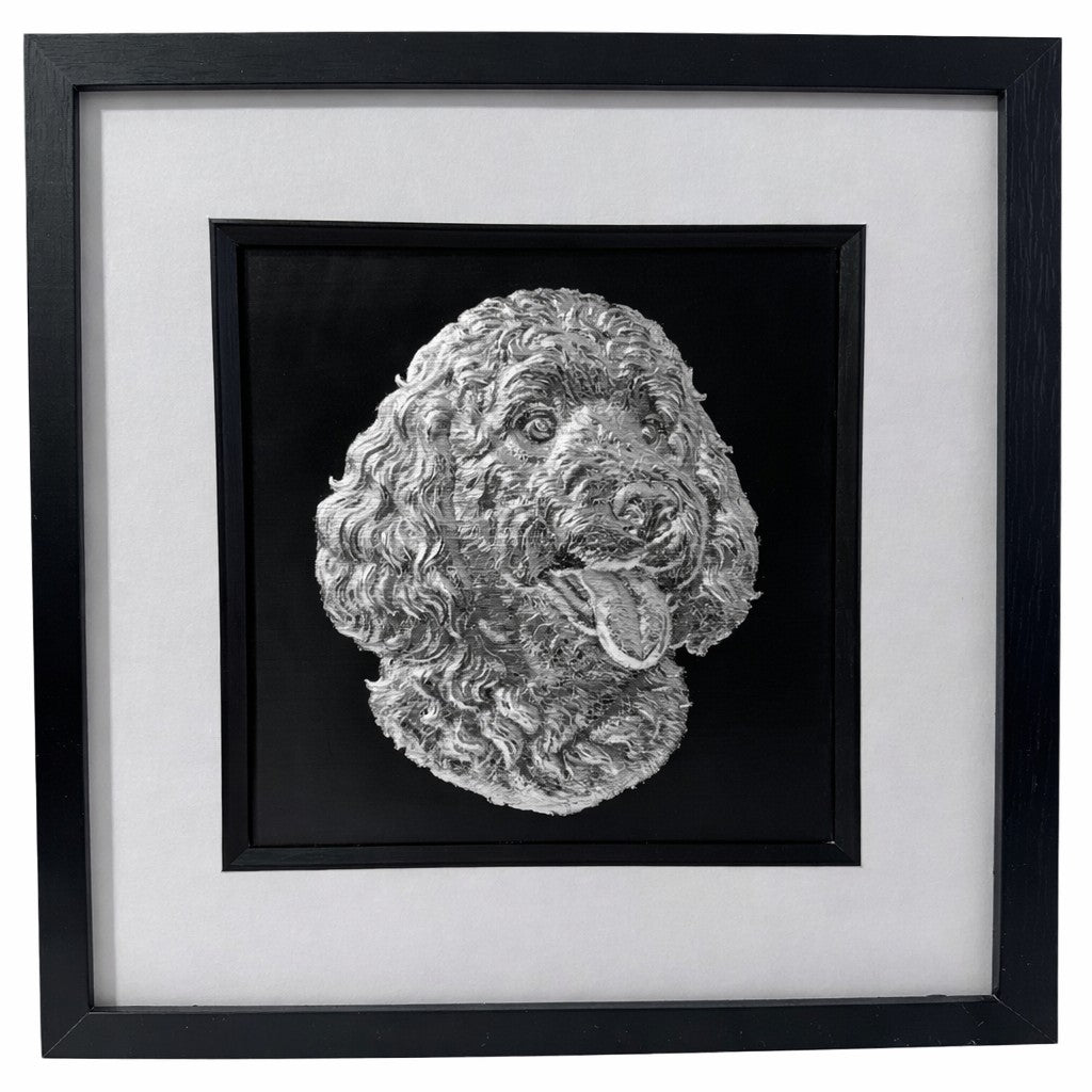 Goldendoodle framed wall art showing a sculpted dog portrait with curly coat in silver leaf, set on a black background with white mount and black wooden frame