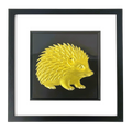 Front-facing gold leaf hedgehog wall art with black background and white mount