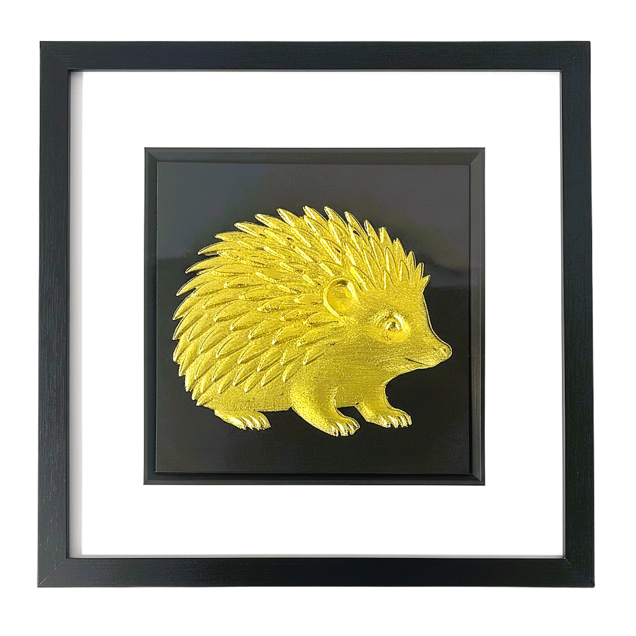 Front-facing gold leaf hedgehog wall art with black background and white mount