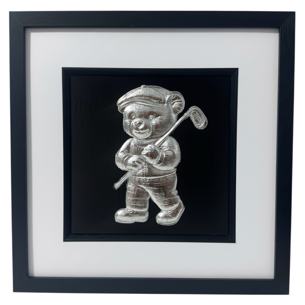 Silver 3D relief wall art of bear in golf cap on black background.